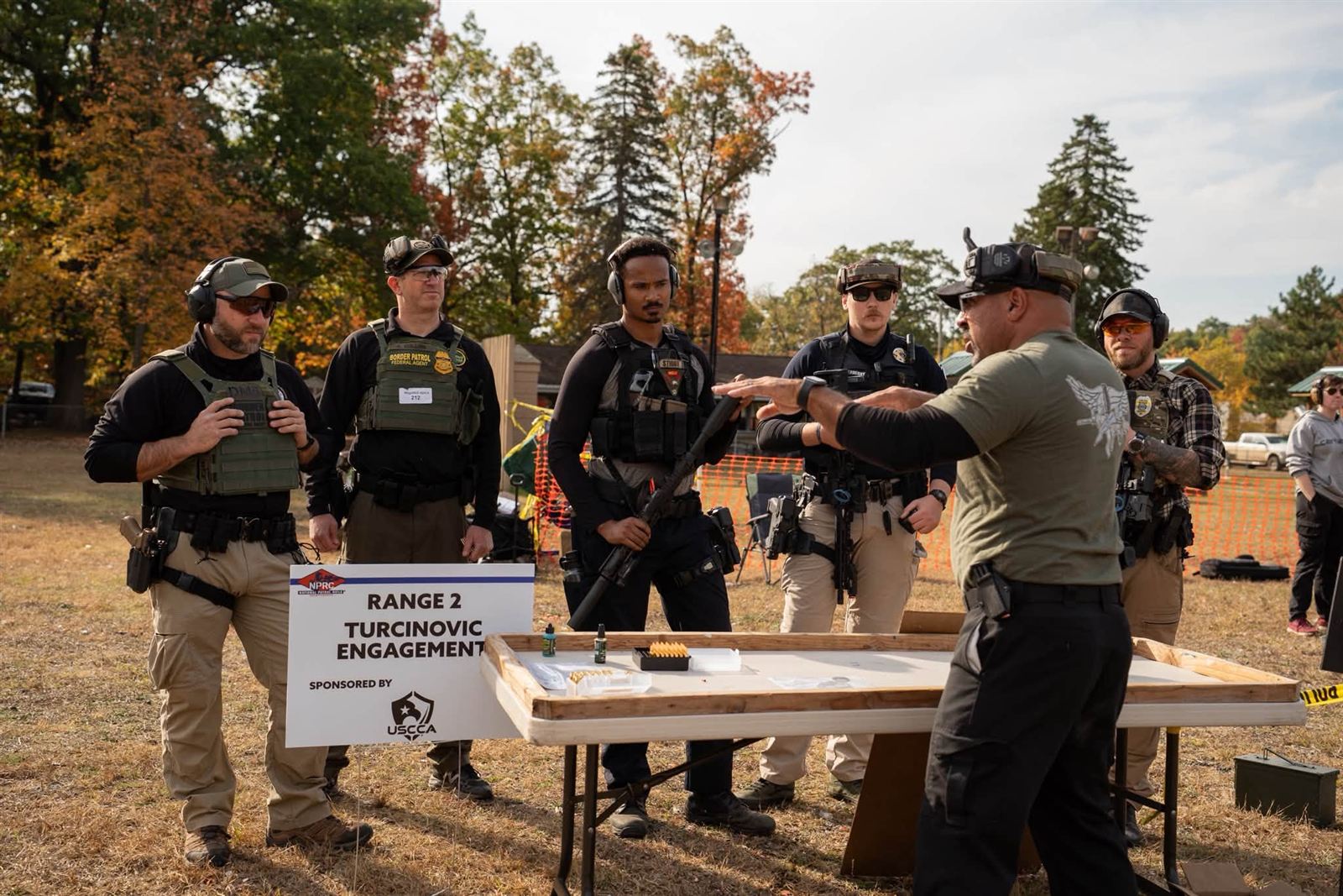 An instructor briefing competitors before a course of fire