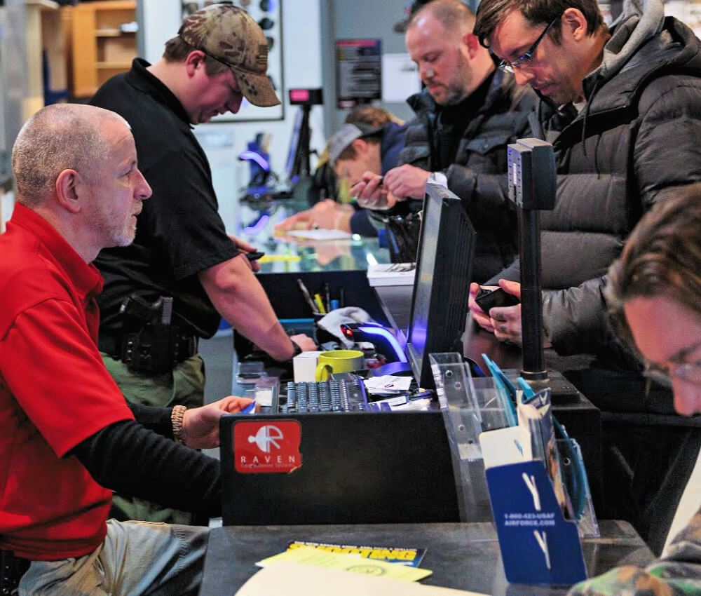 Customers and staff at the Center Mass showroom counter